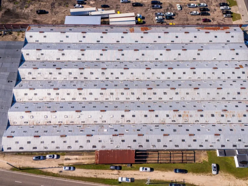 Aerial view of a large commercial building with a low slope roof