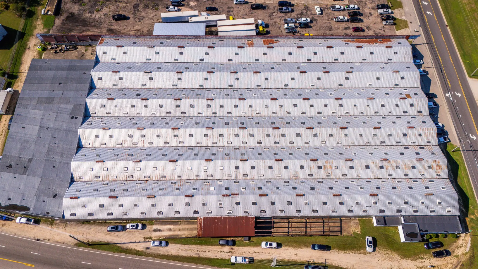 Aerial view of a large commercial building with a low slope roof