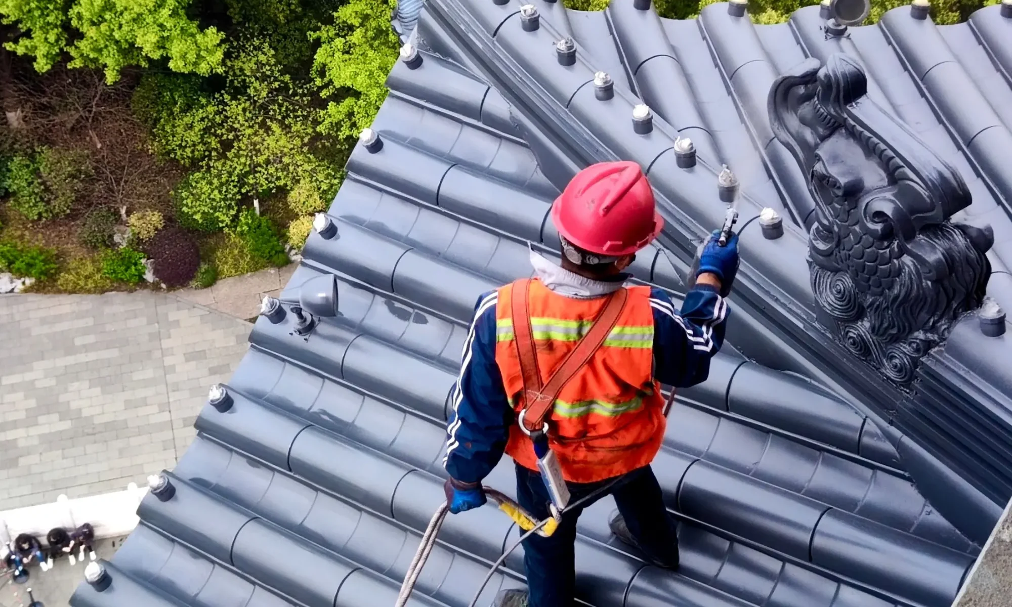 Roofer in safety gear inspecting a roof
