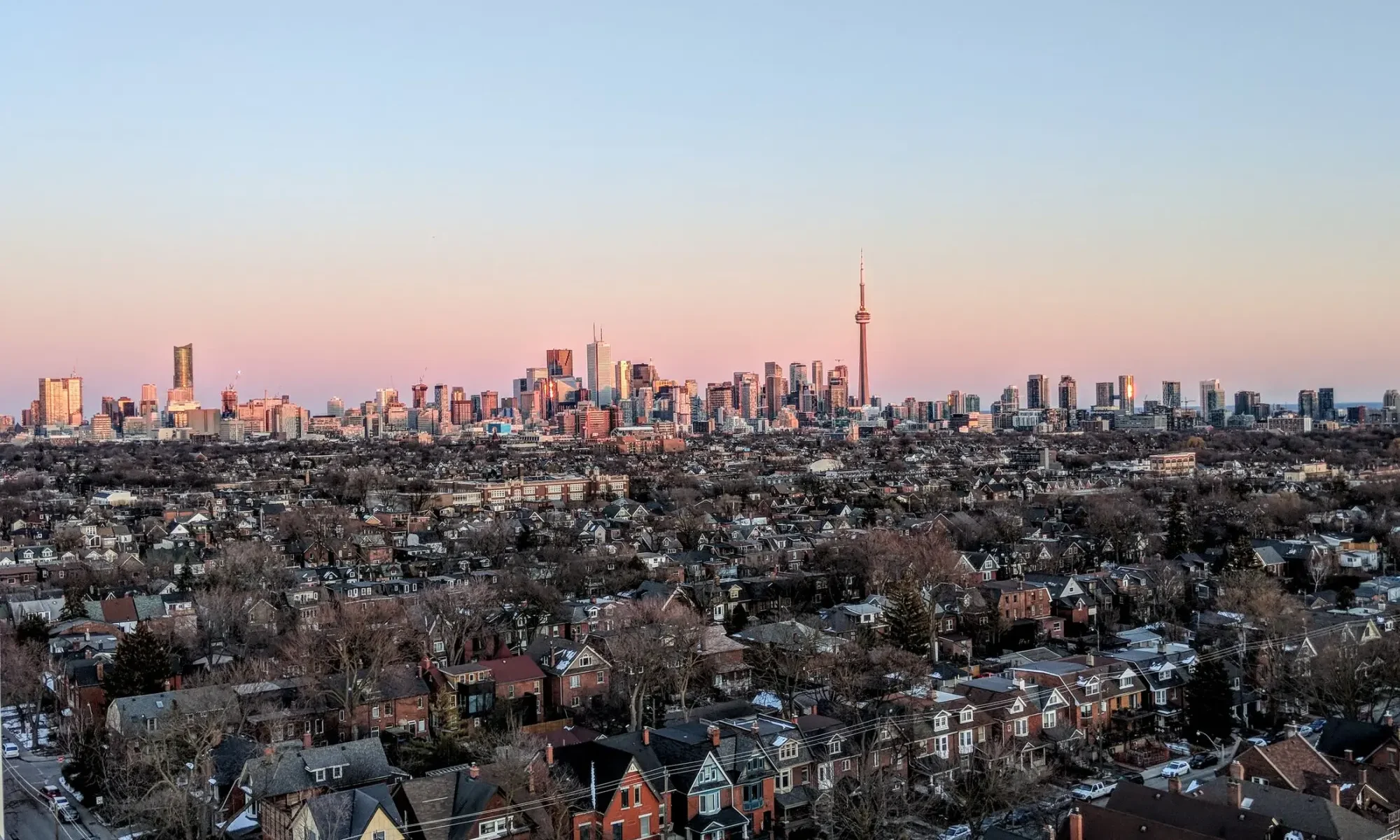 Toronto residential neighbourhood and skyline with the CN Tower at sunset